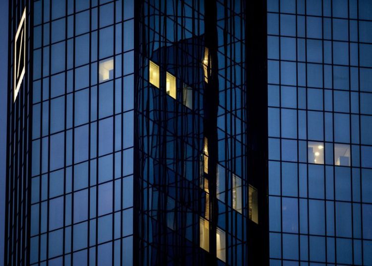 A few lights are on in the offices of the Deutsche Bank headquarters in Frankfurt, Germany, Wednesday, Jan. 27, 2021 as the partial lockdown in Germany goes on