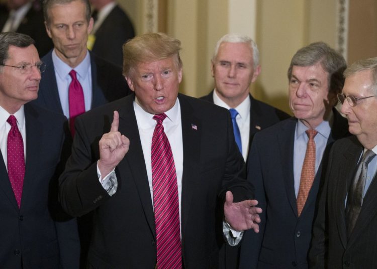 FILE - In this Wednesday, Jan. 9, 2019 file photo, Sen. John Barrasso, R-Wyo., left, and Sen. John Thune, R-S.D., stand with President Donald Trump, Vice President Mike Pence, Sen. Roy Blunt, R-Mo., and Senate Majority Leader Mitch McConnell of Ky., as Trump speaks while departing after a Senate Republican Policy luncheon, on Capitol Hill in Washington. The Republican Party still belongs to Donald Trump. The GOP privately flirted with purging the norm-shattering former president after he incited a deadly riot at the U.S. Capitol last month. But in the end, only seven of 50 Senate Republicans voted to convict Trump in his historic second impeachment trial on Saturday, Feb. 13, 2021