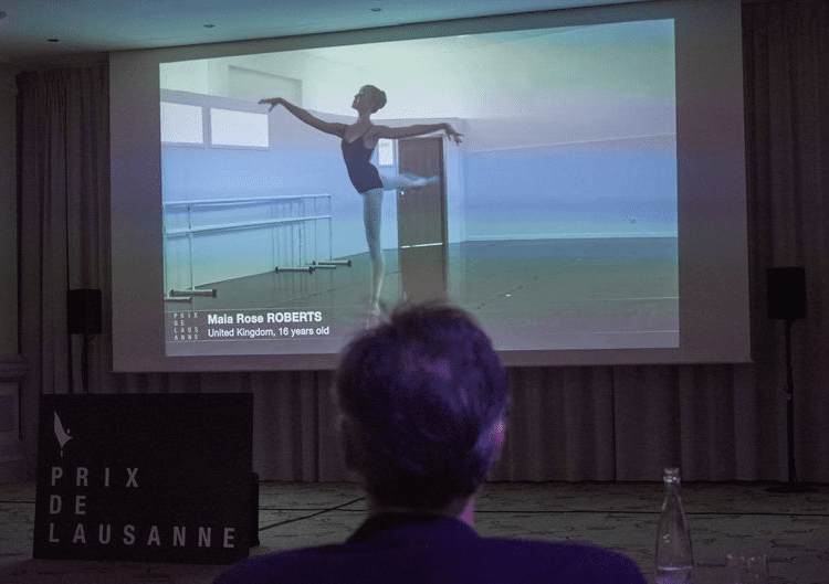 Jury member Nicolas Le Riche looks at a screen displaying a prerecorded video of dancer Maia Rose Roberts during the 49th Prix de Lausanne in Lausanne, Switzerland.