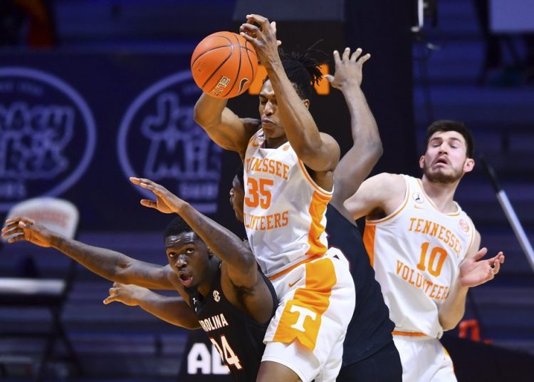 Tennessee's Yves Pons (35) attempts to get control of the ball over South Carolina's Keyshawn Bryant (24) during an NCAA college basketball game Wednesday, Feb. 17, 2021, in Knoxville, Tenn.