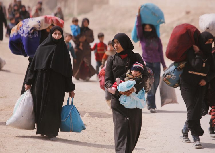 On 15 March 2018 in Beit Sawa, eastern Ghouta. families walk towards Hamourieh where an evacuation exit from eastern Ghouta has been opened.  In March 2018, thousands of people reportedly left Hammouriyeh in eastern Ghouta, following reports of fierce fighting that resulted in civilian deaths and injuries, as well as damage to civilian infrastructure. The actual number of people who have exited eastern Ghouta is not known, at the time of reporting busses were still arriving for more evacuees.  The United Nations has not observed the evacuations, but is visiting collective shelters where some of the evacuees are arriving. This includes the Dweir collective center, where families are being assisted by the Syrian Arab Red Crescent with non-food items, hygiene kits, and ready-to-eat food. The shelter has a staffed medical point, water and electricity.  Since the beginning of the first evacuations on the 11 March, UNICEF and partners started its emergency response. Many of these actions are still ongoing as evacuees continue to arrive at the reception centres. At Dweir reception centre, with the local Department of Health UNICEF distributed High Energy Biscuits, plumpy paste, Multi-micro Nutrient tablets and powder. Women and Children are being checked and screened for malnutrition and provided with proper supplies when needed. Further supplies are being sent to Dweir to continue the direct distribution to evacuees. Children under-5 are also being vaccinated with the Oral Polio Vaccine and given their routine immunizations if they had not received them. A mobile health team has also been deployed to Dweir to provide further health and nutrition services to children and mother. 5,000 brochures with awareness messages on prevention of child separation (including plastic bracelets with tags for parents to write names and contact information of a childs parents) have been dispatched to the reception centre. Winter clothes sets are being disturbed for children under the
