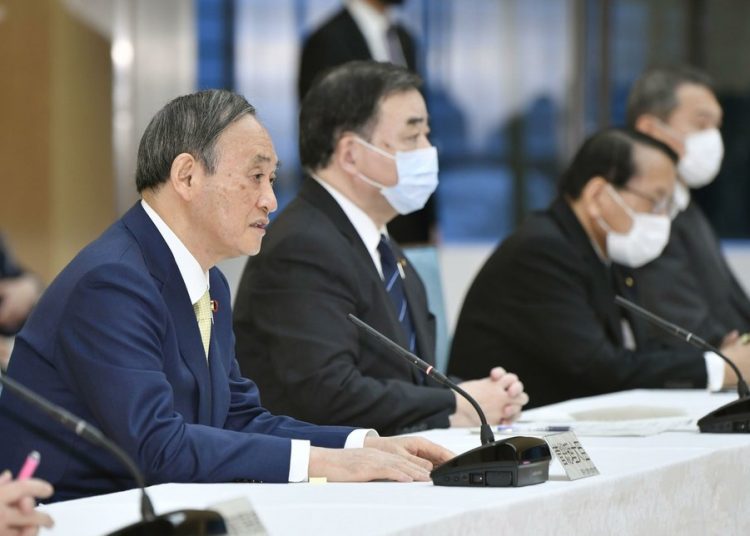 Japanese Prime Minister Yoshihide Suga attends a cabinet meeting at his official residence in Tokyo Tuesday.
