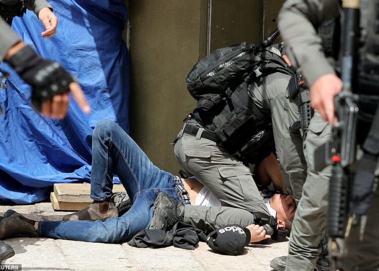 21 people killed in Israeli strike on Gaza, including 9 children 1 - Egyptian Gazette Israeli police detain a protester near the compound that houses the Al-Aqsa Mosque during clashes