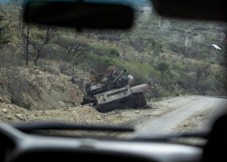 A destroyed tank sits by the side of a road leading to Abi Adi, in the Tigray region of northern Ethiopia.