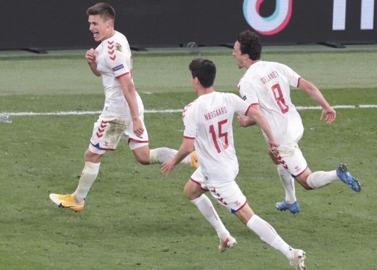 Denmark's Joakim Maehle (L) celebrates after scoring his side's fourth goal during their Euro 2020 group B match against Russia in Copenhagen.