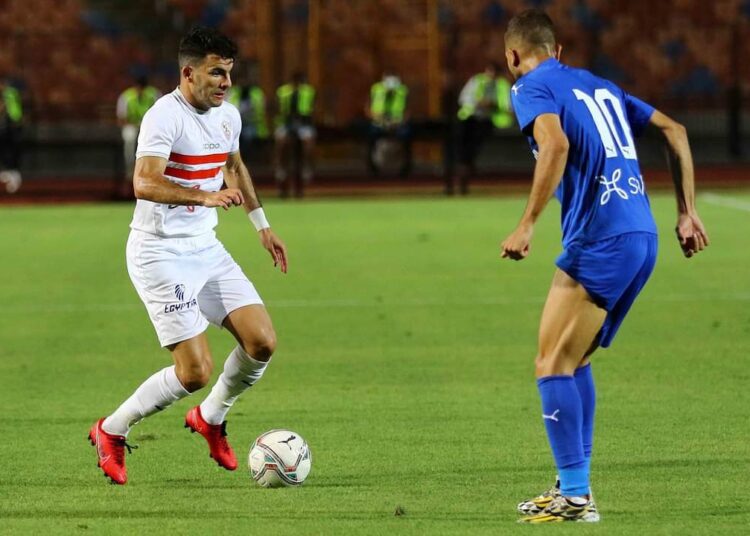Zamalek's winger Ahmed Sayed 'Zizo' (L) vying for the ball against Aswan left-back player Amr El Halwani during their match at the 26th week of the 2020-21 Egyptian Premier League season.