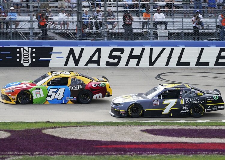 Kyle Busch (54) leads Justin Allgaier (7) during a NASCAR Xfinity Series auto race at Nashville Superspeedway, in Lebanon, Tennessee.