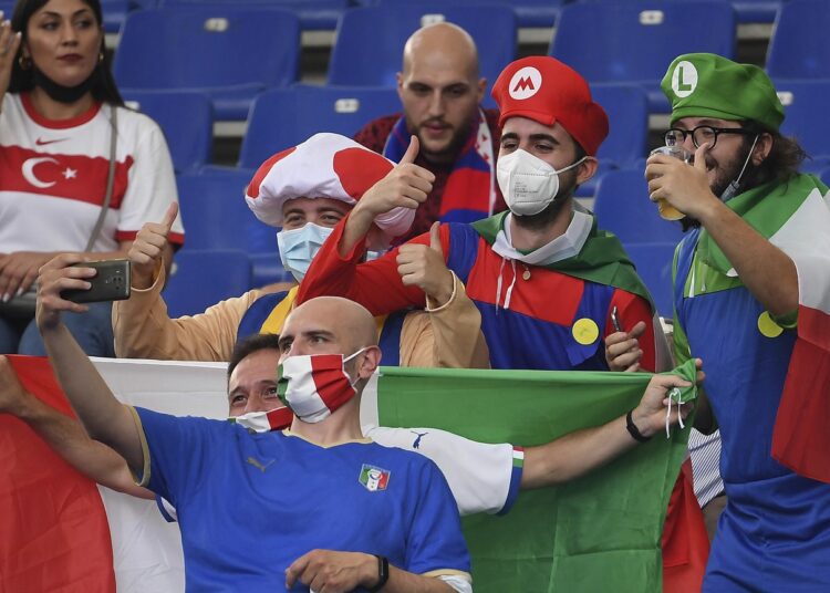 Italy coach hails win in Euro opener 1 - Egyptian Gazette Fans take selfies with their phone before the Euro 2020 championship group A match between Turkey and Italy at the Olympic stadium in Rome.