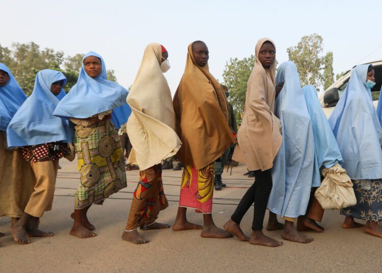 Girls who were kidnapped from a boarding school in the northwest Nigerian state of Zamfara walk in line after their release, in Zamfara, Nigeria, March 2, 2021.