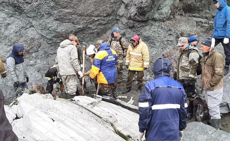 Photo shows Emergency Situations Ministry workers at the wreckage of a missing Antonov An-26 missing plane found near its destination airport outside the town of Palana, in Russia's Far East.