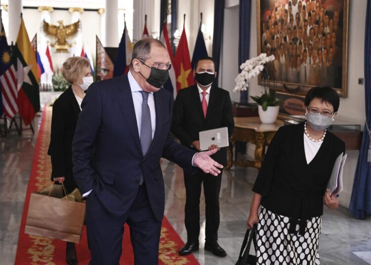 Russian Foreign Minister Sergei Lavrov, left, walks with his Indonesian counterpart Marsudi, right, after their meeting in Jakarta, Indonesia, Tuesday, July 6, 2021.