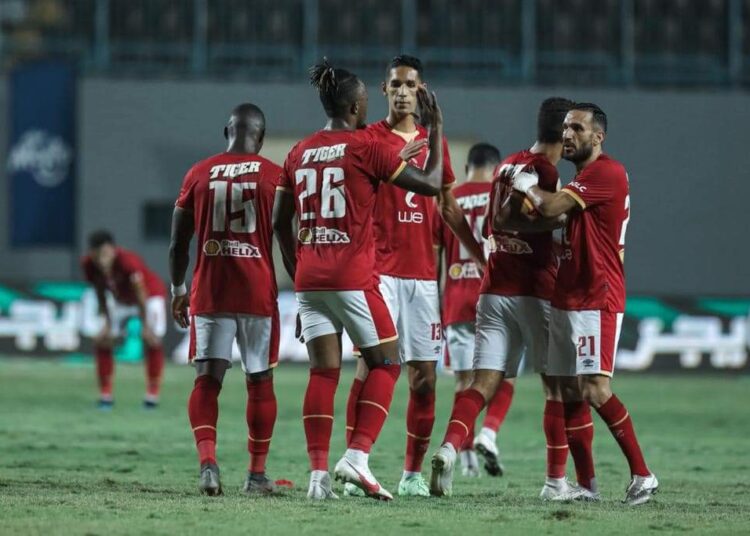 Al-Ahly players celebrating after scoring against Arab Contractors at Cairo's Petrosport Stadium.