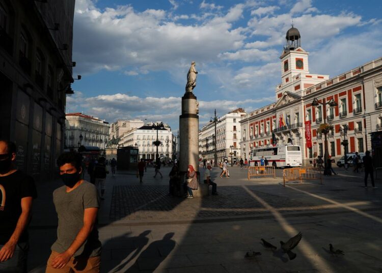 People hanging out at Madrid's landmark Puerta del Sol square, Spain, June 7, 2021.