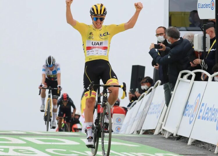 UAE Team Emirates rider Tadej Pogacar of Slovenia wearing the yellow jersey celebrates as he wins the 18th stage of the Tour de France.
