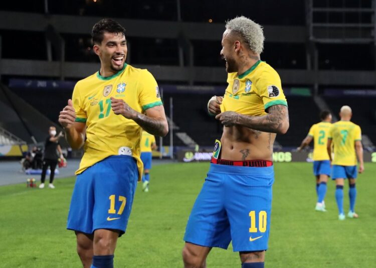 Brazil's Lucas Paqueta celebrates scoring first goal against Peru with Neymar at Estadio Nilton Santos.