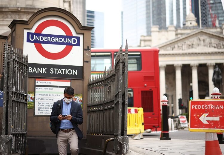 A person exits Bank underground station in the City of London financial district, in London, Britain, June 11, 2021.