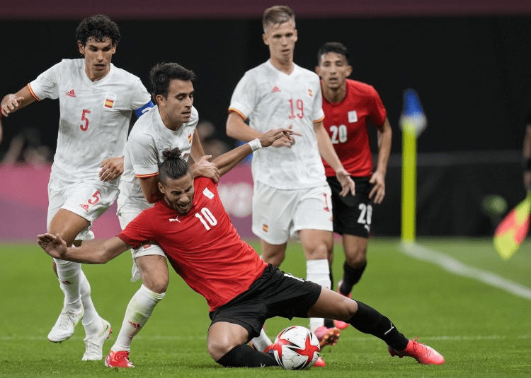 Egypt’s Ramadan Sobhi falls challenged by players from Spain during a men’s soccer match at the 2020 Summer Olympics, Thursday, July 22, 2021, in Sapporo, Japan.