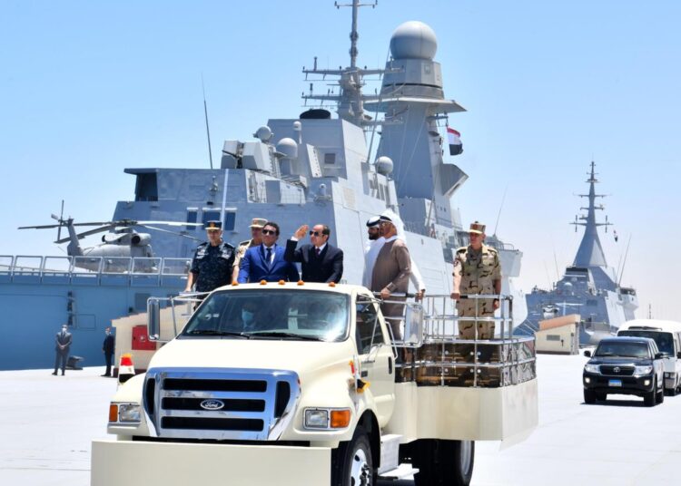 President Sisi saluting troops on board of a multi-role Egyptian frigate as he, Crown Prince bin Zayed and Chairman al-Manfi tour the new 3rd of July Naval Base.