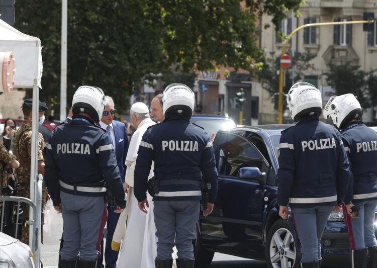 Pope Francis stops to greet police that escorted him as he arrives at the Vatican after leaving the hospital on his Ford, 10 days after undergoing planned surgery to remove half his colon Wednesday, July 14, 2021. Francis had half of his colon removed for a severe narrowing of his large intestine on July 4, his first major surgery since he became pope in 2013.