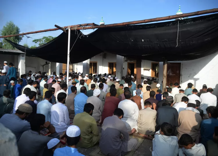 Biden authorizes $100m in emergency funds for Afghan refugees 1 - Egyptian Gazette Afghan refugees offer Eid al-Adha prayers at a mosque in the Kazana Refugee camp on the outskirts of Peshawar, Pakistan, July 20, 2021.