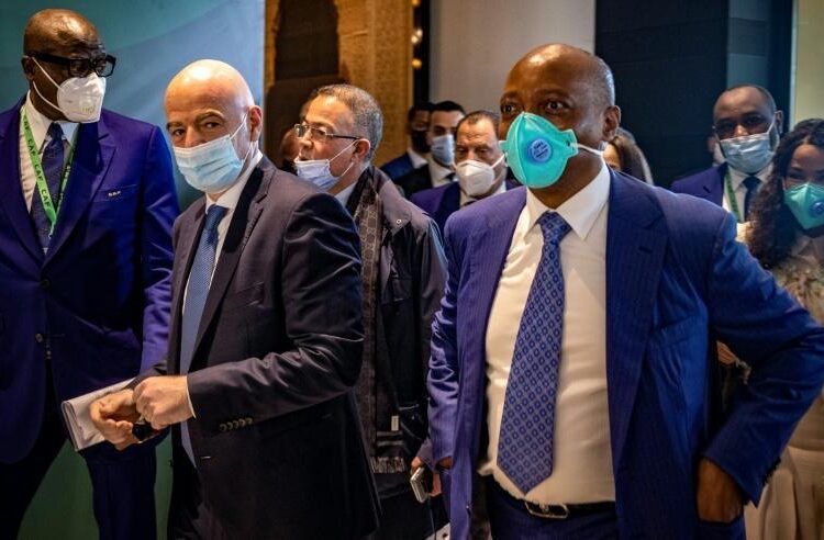 FIFA president Gianni Infantino (L) and new CAF president Patrice Motsepe (R) arrive for the general assembly of the African football body on March 12, 2021 in Rabat.