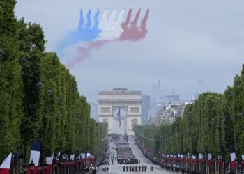 France cautiously celebrates Bastille Day, clouded by virus