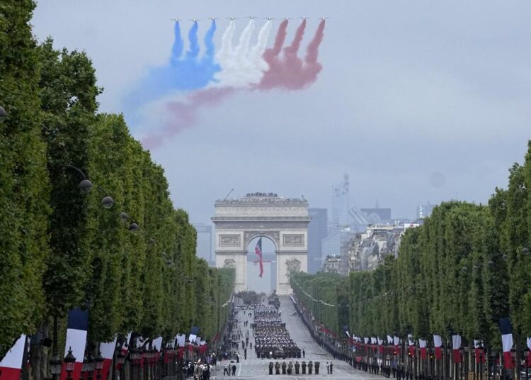 Jets of the Patrouille de France fly over the Champs-Elysees avenue during the Bastille Day parade, on Wednesday,  in Paris.
