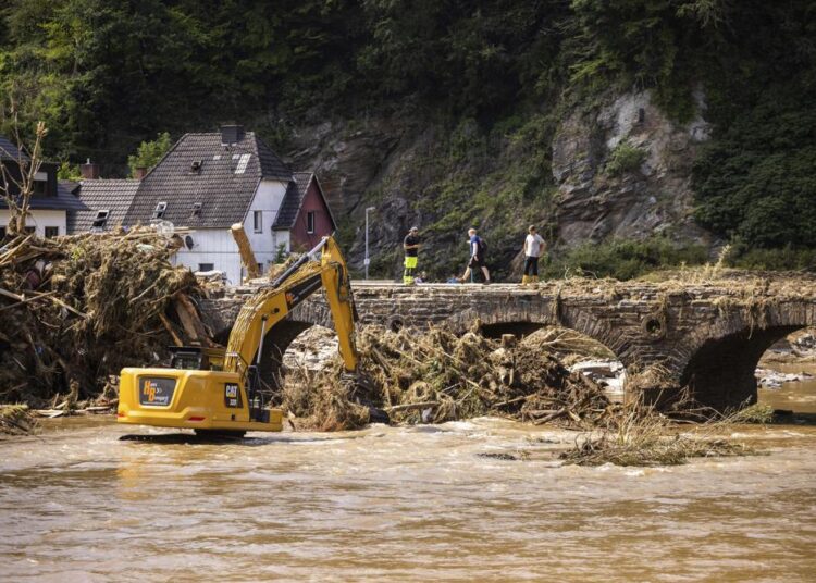 An excavator clears debris from the river Ahr, in Ahrbruck, Germany.