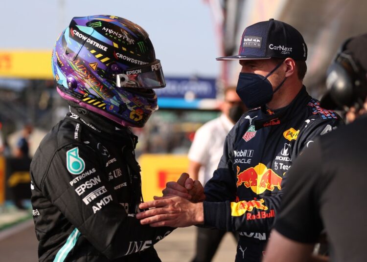 Mercedes' Lewis Hamilton shakes hands with Red Bull's Max Verstappen at the Silverstone Circuit July 16, 2021.