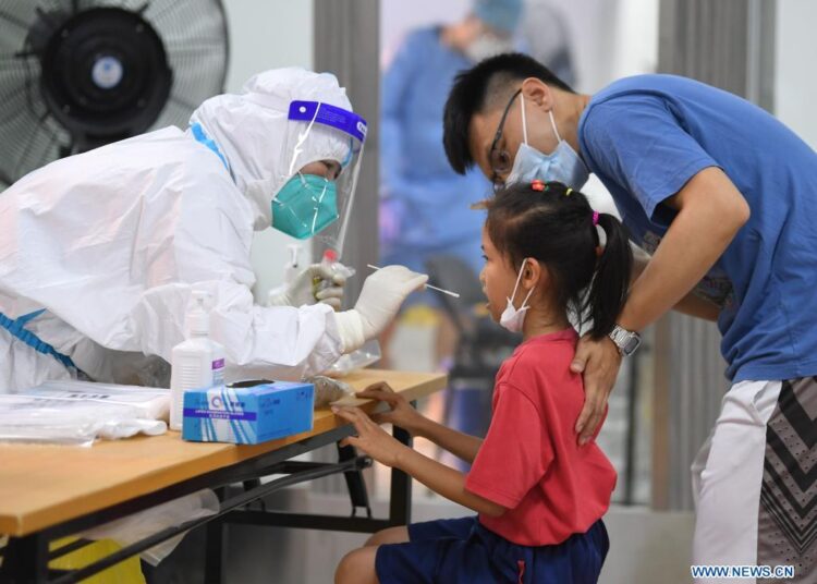 A medical worker collecting swab sample for nucleic acid testing in Liwan district of Guangzhou, South China's Guangdong province.
