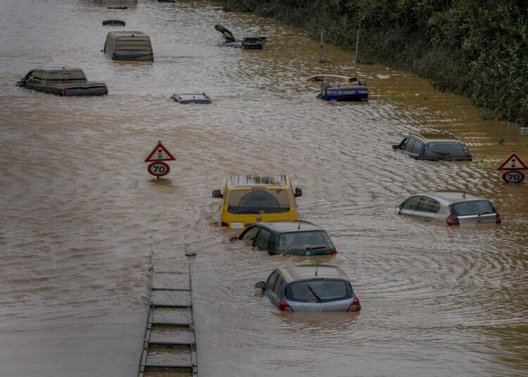 Cars showing up as the flood sinks on a road in Erftstadt, Germany on Saturday