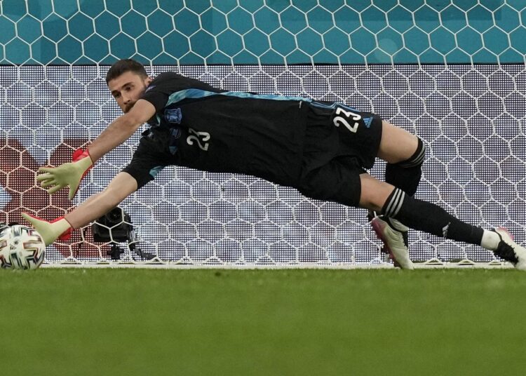 Spain's goalkeeper Unai Simon stops a penalty shot from Switzerland's Manuel Akanji during a penalty shootout after extra time during their Euro 2020 quarter-final match in St. Petersburg, Russia.