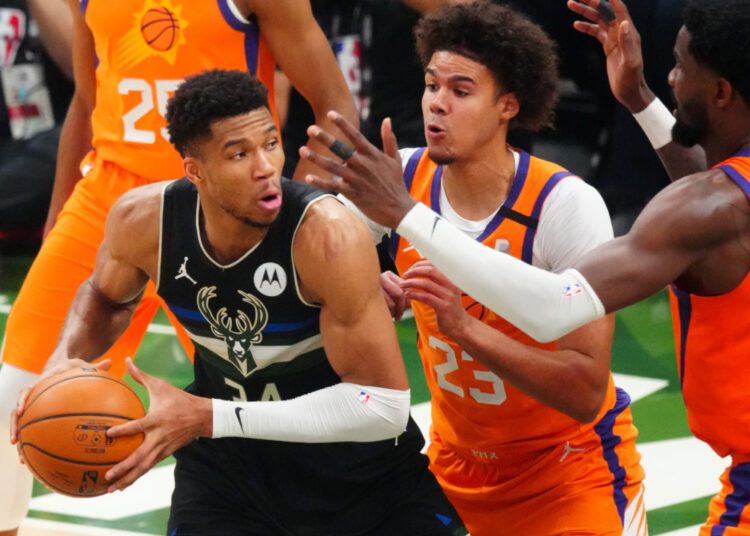 Milwaukee Bucks forward Giannis Antetokounmpo (34) drives against Phoenix Suns forward Cameron Johnson (23) during the 2021 NBA Finals.