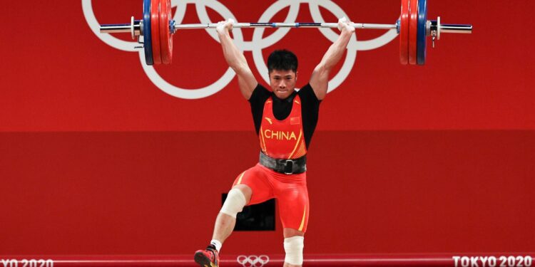 Li Fabin of Team China competes during the men's 61kg weightlifting event at the 2020 Olympic Games.