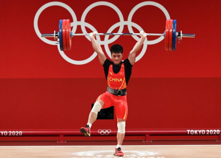 Li Fabin of Team China competes during the men's 61kg weightlifting event at the 2020 Olympic Games.