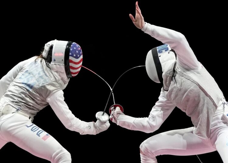 Inna Deriglazova of Russia, right, and Lee Kiefer of the United States compete in the women's individual Foil final competition at the 2020 Olympics, in Chiba, Japan.