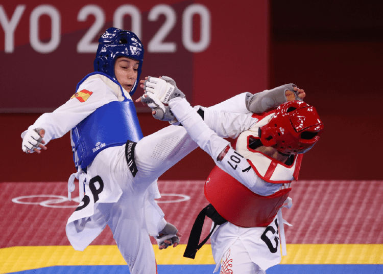 Olympics-Taekwondo: Teenagers cause upsets, Thai queen nabs gold 1 - Egyptian Gazette Spain's Adriana Cerezo Iglesias (L) in action against China's Wu Jingyu in the taekwondo competitions at the Tokyo Olympics.
