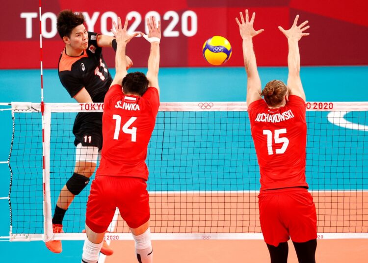 Yuji Nishida of Japan in action with Aleksander Sliwka of Poland and Jakub Kochanowski of Poland at the Tokyo Olympics.