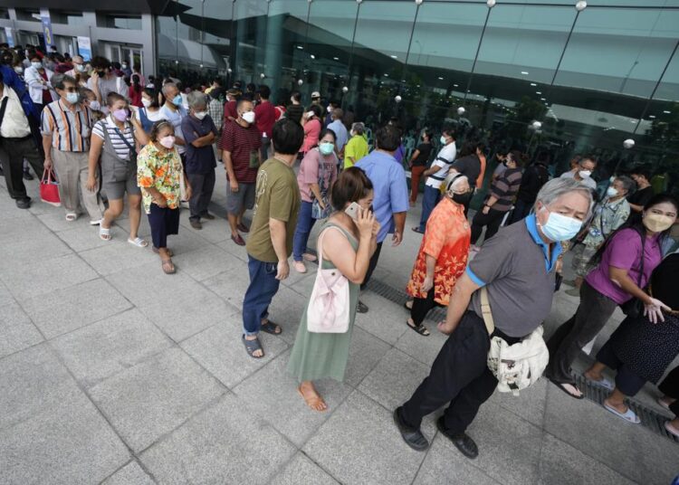 Residents wait on line to receive shots of the AstraZeneca COVID-19 vaccine at the Central Vaccination Center in Bangkok, Thailand, on Thursday.