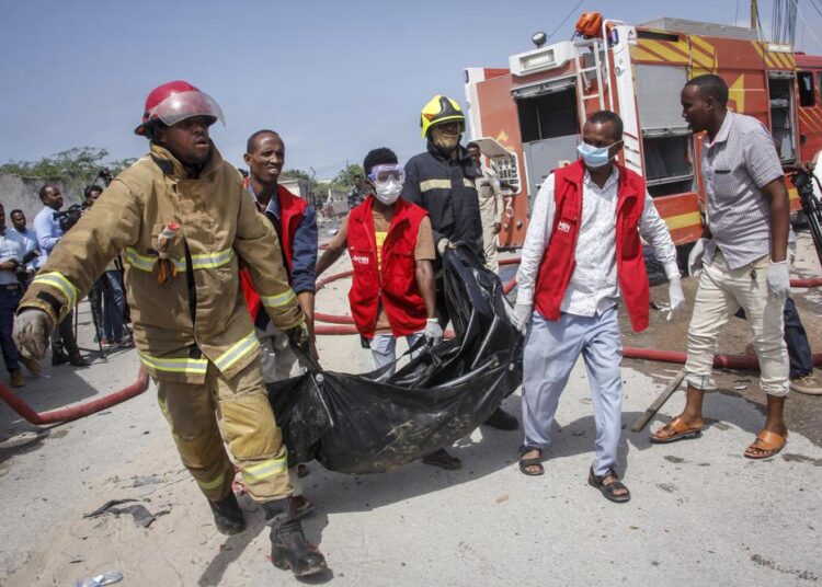 Medical workers carrying the body of a civilian who was killed in a suicide car bomb attack in Mogadishu on Saturday.