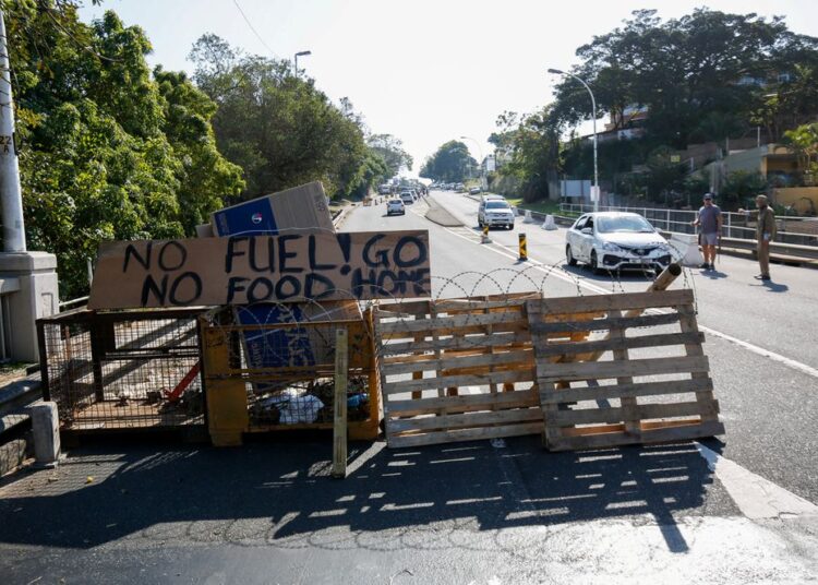 Community members monitor access to a suburb after several days of looting following the imprisonment of former South Africa President Jacob Zuma, in Durban, South Africa.