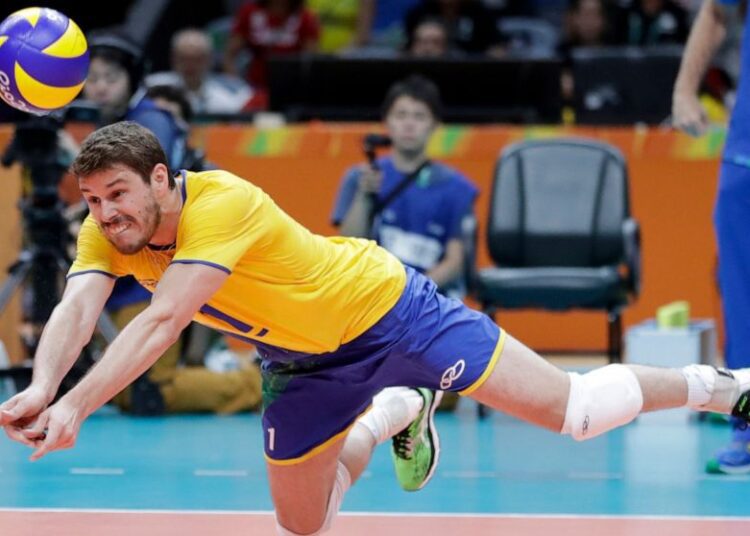 In this Aug. 9, 2016, file photo, Brazil's Bruno Rezende dives for the ball during a men's preliminary volleyball match against Canada at the Summer Olympics in Rio de Janeiro.