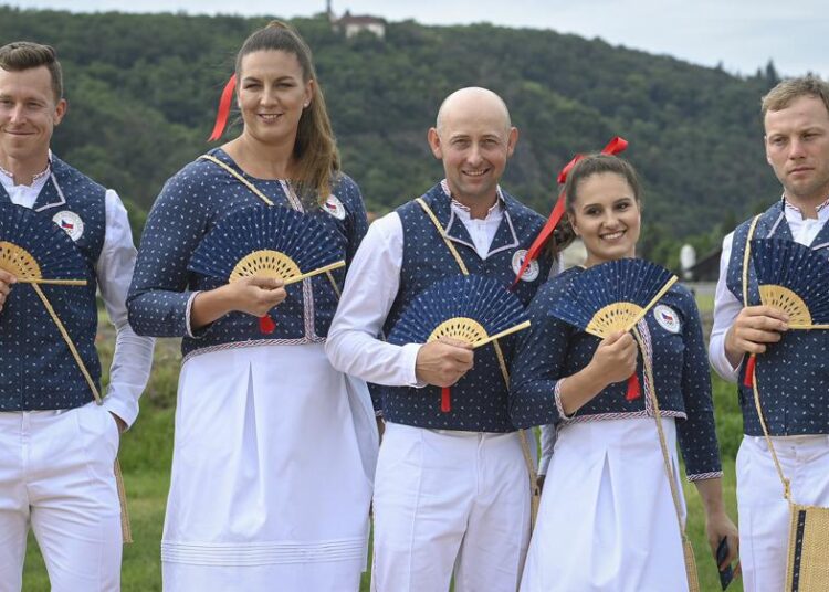 From left, Czech track cyclist Tomas Babek, hammer thrower Katerina Safrankova, rider Miroslav Trunda, artistic gymnast Aneta Holasova and rider Miloslav Prihoda, pose wearing the new olympic uniforms for The Tokyo Olympic Summer Games 2020, in Prague, Czech Republic, Tuesday, June 22, 2021.