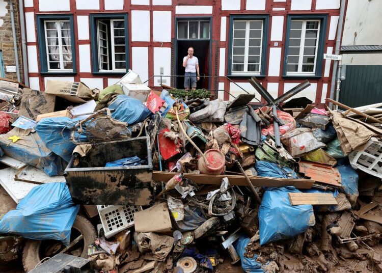 A man looks on outside a house in an area affected by floods caused by heavy rainfalls in Bad Muenstereifel, Germany.