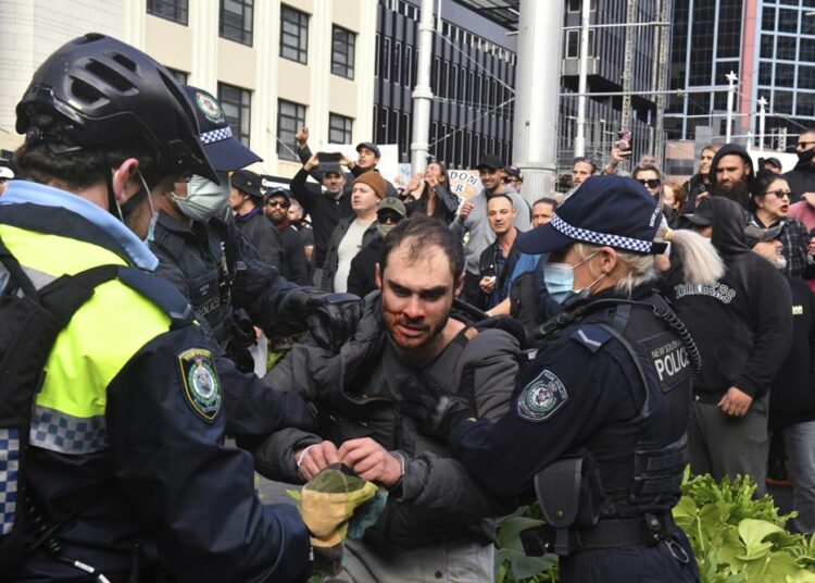 A protester, C, is arrested by police at a demonstration at Sydney Town Hall during a 'World Wide Rally For Freedom' anti-lockdown rally in Sydney, Saturday, July 24, 2021.