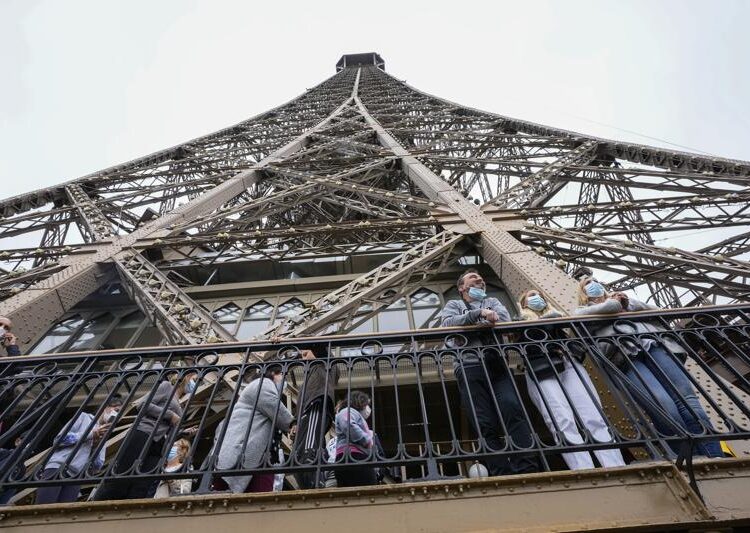 France allows visitors with Indian-made AstraZeneca vaccine 1 - Egyptian Gazette Visitors enjoy the view from the Eiffel Tower in Paris, Friday, July 16, 2021. The Eiffel Tower is reopening Friday for the first time in nine months, just as France faces new virus rules aimed at taming the fast-spreading delta variant. The "Iron Lady" was ordered shut in October as France battled its second surge of the virus. (AP Photo/Michel Euler)