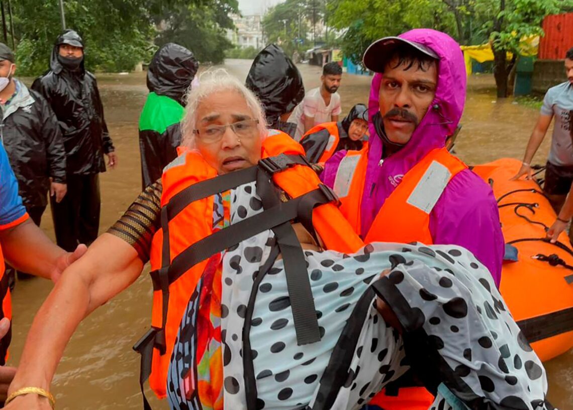 Rescue teams in India struggled through thick sludge and debris on Saturday to reach dozens of submerged homes as the death toll from landslides and accidents caused by torrential monsoon rain rose to 125.