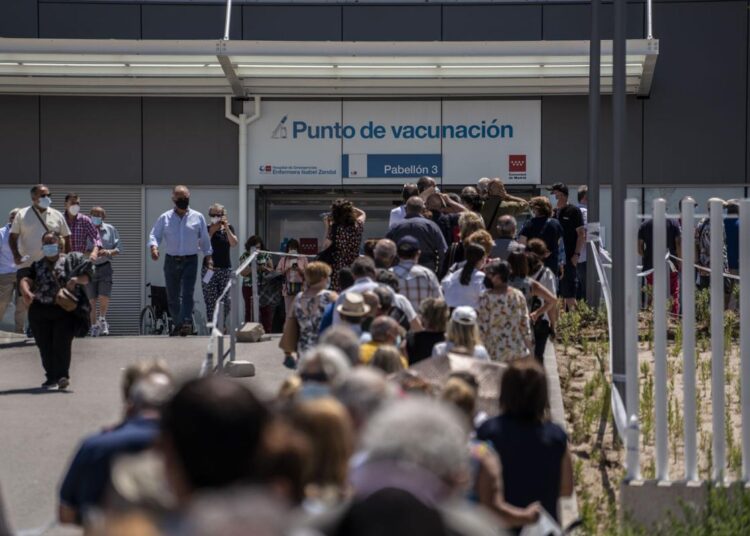 Hundreds of people queue to be vaccinated against COVID-19 at the Enfermera Isabel Zendal Hospital in Madrid, Spain, Tuesday, July 7, 2021.