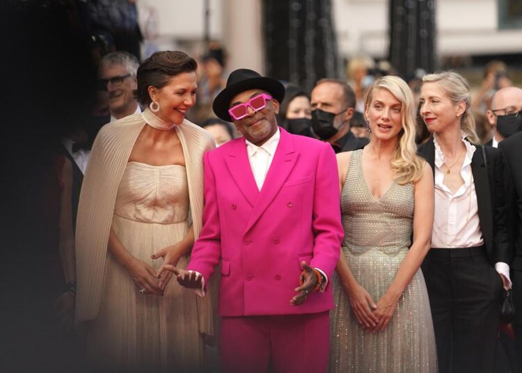 Jury president Spike Lee, second from left, poses with jury members Maggie Gyllenhaal, from left, Melanie Laurent and Jessica Hausner at the premiere of the film 'Annette' and the opening ceremony of the 74th international film festival, Cannes, southern France, Tuesday, July 6, 2021. (AP Photo/Brynn Anderson).