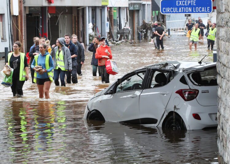 Youths and scouts carry bread to offer to residents affected by floods, following heavy rainfalls, in Pepinster, Belgium,  Herman